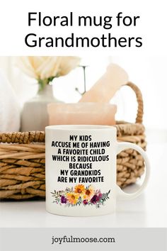 a coffee mug with the words floral mug for grandmothers on it next to some flowers