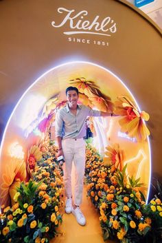 a man standing in front of a flower display