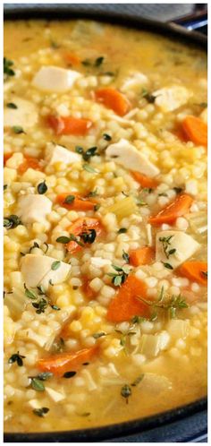 a pot filled with corn and carrots on top of a stove