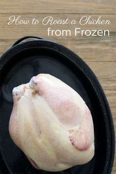 raw chicken in a cast iron skillet with text overlay how to roast a chicken from frozen