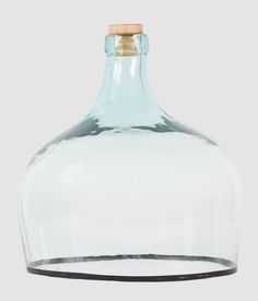 an empty glass bottle with a wooden top