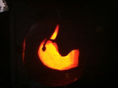 a cat carved into a pumpkin in the dark