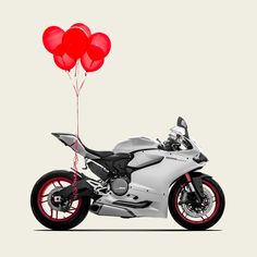 a motorcycle with two red balloons attached to it