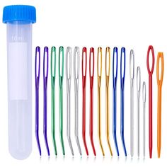 a group of different colored straws next to a plastic tube with scissors in it