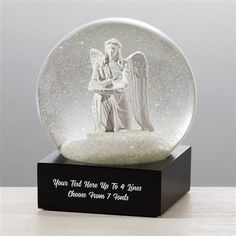 a snow globe with an angel holding a baby jesus on it's lap and saying your wings were ready, but the story not