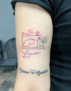 a woman's arm with a sewing machine tattoo on the left side of her arm