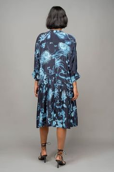 Blue dress with garden print, kimono sleeves and pleated back. - Aza Fashions Blue Summer Dresses With Pleated Sleeves, Blue Midi Dress With Pleated Back, Blue Midi Dress With Pleated Sleeves For Spring, Blue Dresses With Pleated Short Sleeves, Blue Spring Midi Dress With Pleated Back, Blue Pleated Hem Summer Dresses, Blue Pleated Hem Dress For Summer, Spring Blue Midi Dress With Pleated Back, Blue Pleated Dress With Pleated Hem For Spring