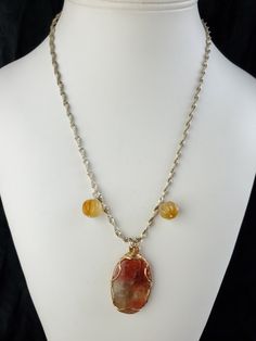 "Large oval sun stone pendant with specially designed gold filled mounting of wide cabochon band and wire wrap with a sinuous vintage gold/silver colored necklace, together with two melon shape carnelian. One of a kind. Necklace measures 22\" long, pendant 1.5\".  How to clean precious stones?  Brass does tarnish. Jewelers recommend various methods including dipping the brass - not the stone- into a solution of water and dish soap or lemon juice and salt and water and drying the piece quickly wi Colored Necklace, Sun Stone, Carnelian Stone, Long Pendant, Salt And Water, Colourful Necklace, Woven Bag, Stone Pendant, Lemon Juice