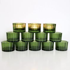 twelve green glass cups with gold rims