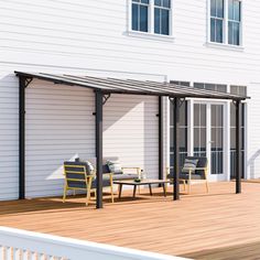 a deck with chairs and table next to a white house