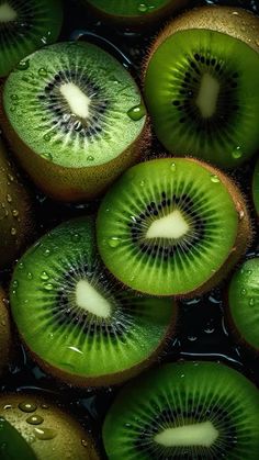 sliced kiwi fruit with water droplets on them