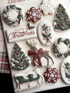 decorated christmas cookies are displayed on a plate