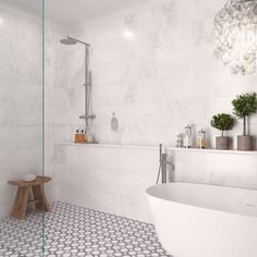 a white bath tub sitting next to a walk in shower under a chandelier