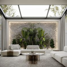 a living room filled with white furniture and plants