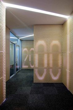 an office building with the number 30 written on it's wall and illuminated in pink