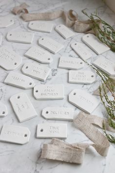 white ceramic tags are laid out on a marble surface