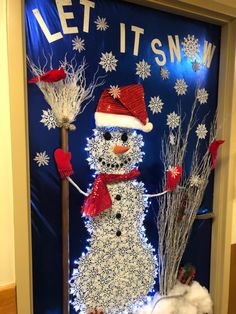 a snowman is standing in front of a door decorated with christmas lights and decorations