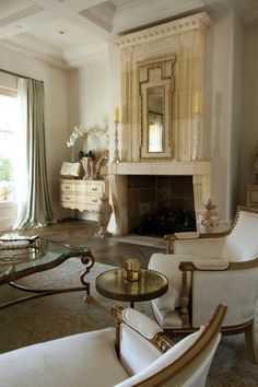 a living room filled with furniture and a fire place in the middle of a room