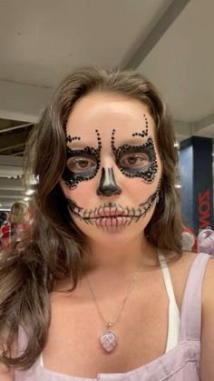 a woman with makeup painted to look like a skeleton