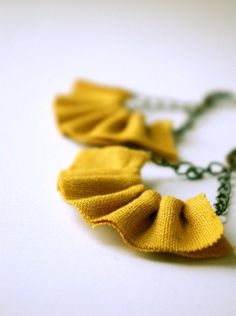 a close up of a necklace on a white surface