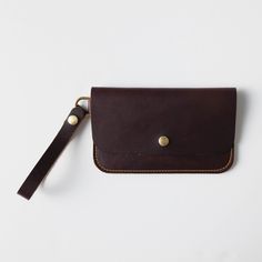 + DIMENSIONS Height: 5.25 inches Width: 8.5 inches Wristlet strap length: 5.5 inches + WRISTLET CLUTCH DETAILS Keep your friends close – and your daily essentials closer. When you need a sleek way to carry the basic necessities, you can't go wrong with KMM & Co.'s leather wristlet clutch. Handmade in the same full-grain leathers as your favorite tote, the wristlet has space for your cards, keys, and phone. Each wristlet clutch features an undivided main compartment, plus a rear pocket that you c Leather Wristlet Pouch With Card Slots, Classic Wristlet Pouch For Everyday Use, Classic Everyday Wristlet Pouch, Classic Everyday Pouch Wristlet, Leather Clutch With Coin Pocket For Everyday Use, Leather Travel Wristlet Pouch, Brown Clutch With Coin Pocket For Everyday Use, Leather Rectangular Wristlet With Removable Pouch, Leather Wristlet With Removable Pouch For Everyday