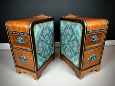 two wooden chests with blue and green designs on them, one is turned upside down