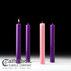 three different colored candles sitting next to each other