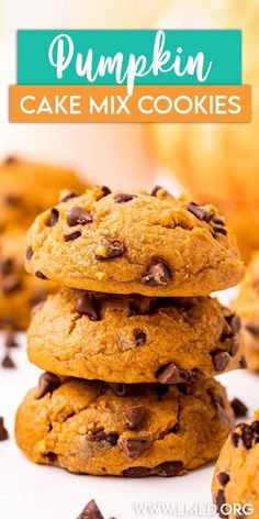 pumpkin cake mix cookies stacked on top of each other with chocolate chips in the background