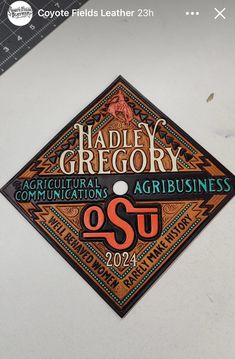 a graduation cap that is on top of a white surface with the words harley greory