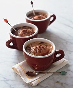 two cups of hot chocolate with spoons in them