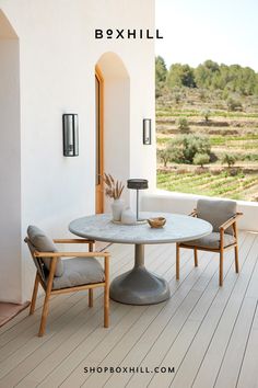 a table and chairs on a porch with the words bexhill above it