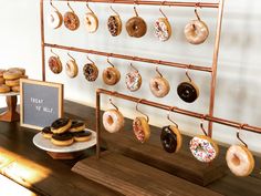 doughnuts are on display in front of a sign