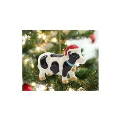 a black and white cow ornament hanging from a christmas tree