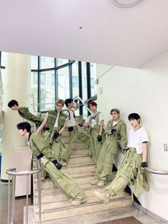 group of young men sitting on steps in uniforms