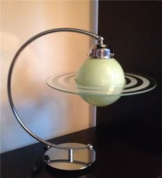 a glass lamp sitting on top of a black table