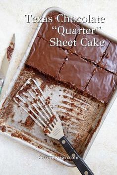 a pan filled with chocolate cake next to a spatula