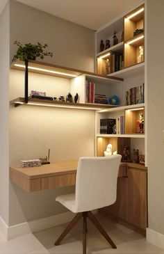 a white chair sitting in front of a desk with bookshelves and shelves above it