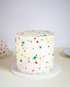 a white cake with colorful sprinkles on it