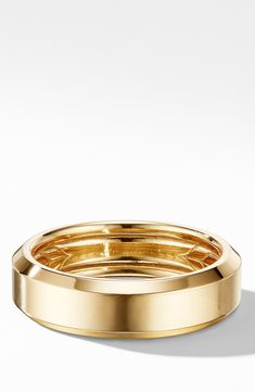 a gold ring on a white background