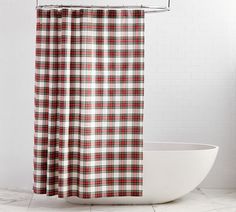 a red and white checkered shower curtain next to a bathtub in a bathroom