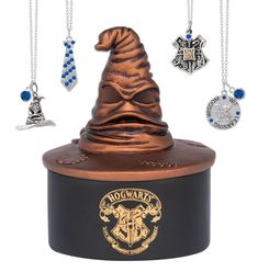 a harry potter hat with charms hanging from it's top on a black container