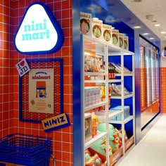 a mini mart store with orange and blue tiles on the walls, shelves filled with items