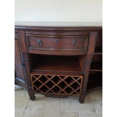 a wooden cabinet with wine bottles on it