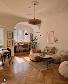 a living room filled with furniture and wooden floors