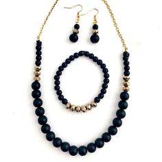 A very pretty jewelry set. Black onyx polished stone beads with gold glass beads in a symmetrical pattern. This necklace measures about 18 inches in length, & the bracelet is beaded on clear strong elastic. The matching earrings measure just over 1.75 inches in length from top to bottom & come with earring backs. (Please contact me if you would like to add a 2-inch extension chain to the necklace). A very unique & pretty black & gold jewelry set! Gold Jewelry Set, Symmetrical Pattern, Semiprecious Stone Jewelry, Black Gold Jewelry, Gold Jewelry Sets, Black Onyx Stone, Stone Gold, Gold Glass, Onyx Stone