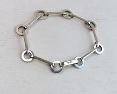 Famous Swedish designer's 'Ring Chain Bracelet' in sterling silver. More about E.Attlings jewelry here https://www.efvaattling.com/products/bracelets/ M a r k e d: Maker's mark EFVA, 925, signature of Efva Attling M e a s u r e s: length 7⅝" or 19.4cm when closed, ring 10mm in diameter  C o n d i t i o n: perfect More Scandinavian sterling silver bracelets here: https://www.etsy.com/shop/AnteBellumTreasure?ref=seller-platform-mcnav&section_id=38968864 Please let me know if you have any Q's. Than Silver Bracelets With Rectangular Links For Anniversary, Modernist Sterling Silver Bracelet As Gift, Modernist Sterling Silver Bracelet Gift, Modern Engraved Sterling Silver Chain Bracelet, Ring Chain Bracelet, Disc Bracelet, Scandinavian Jewelry, Coin Bracelet, Ring Chain