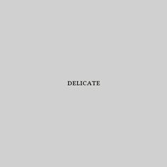 the word delicate is written in black on a gray background with white border