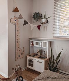 a child's room with toys and decorations on the wall