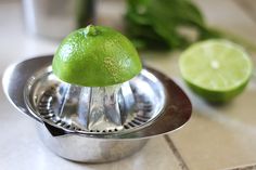 a lime sitting on top of a metal strainer