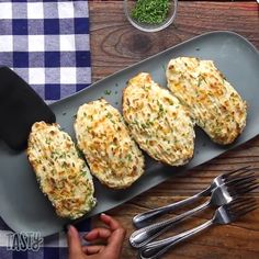 three pieces of chicken are on a plate with a fork and knife next to it